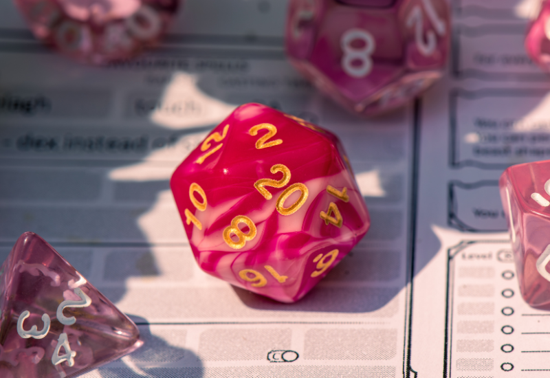 Red d20 dice on a dungeons and dragons character sheet