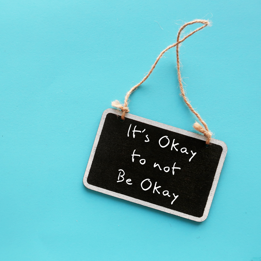 it's ok to not be okay sign on a blue background